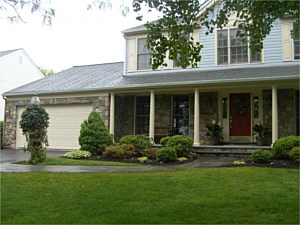 Porch and garage front of the house with natural stone veneer